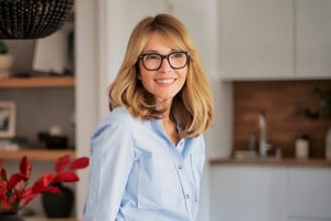Middle-aged blonde woman with a fringe haircut with wispy layers